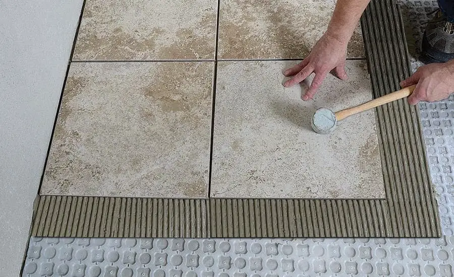 Crack isolation membrane will ensure the same length between tiles and wood.