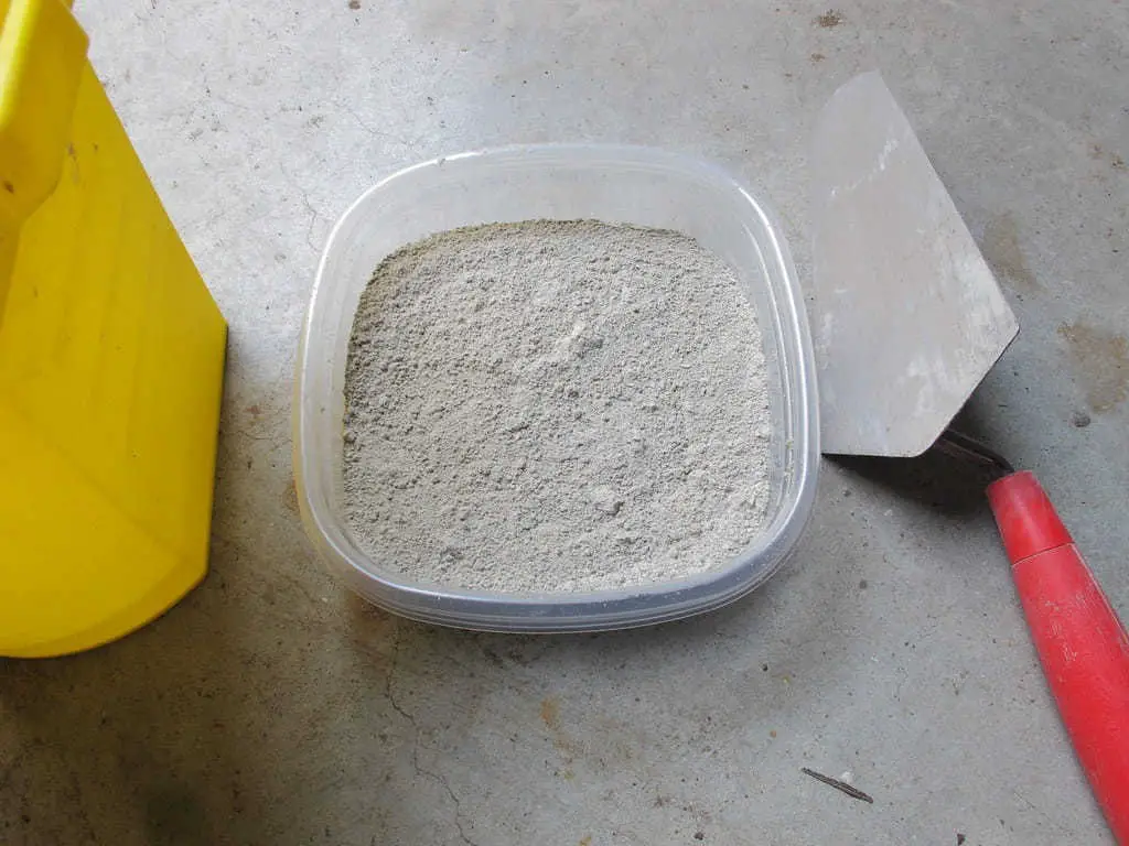 Inspect the consistency of the surface with grout powder.